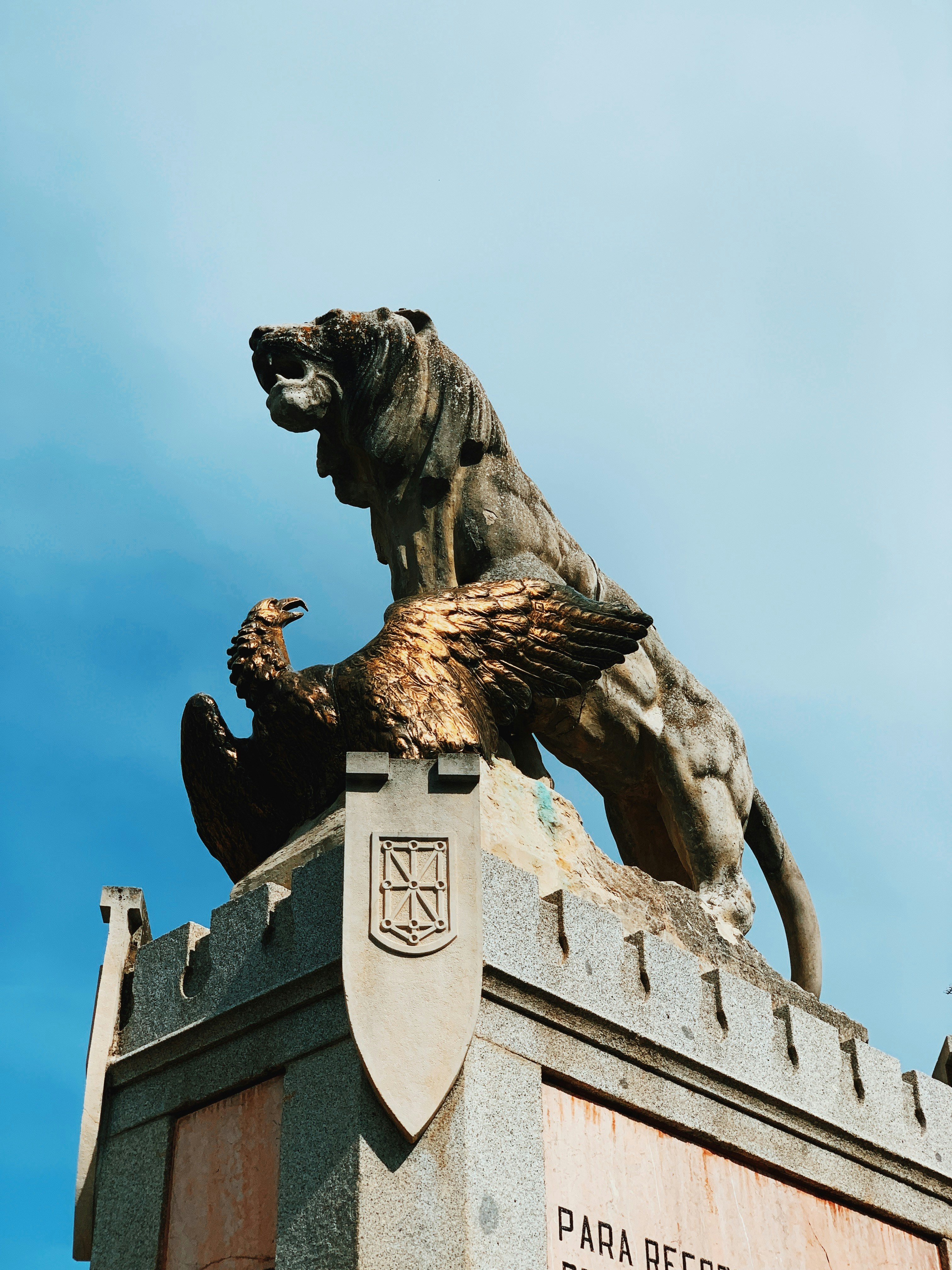 brown lion and brown bird statue